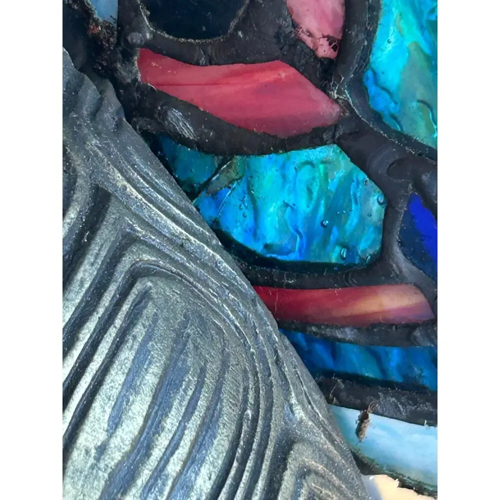 Vintage Tiffany style stained glass butterfly lamp resting on a brass turtle